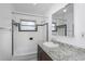 Clean bathroom featuring a granite vanity top and a shower-tub combination with black and white tile at 1881 Stancel Dr, Clearwater, FL 33764