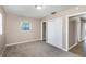 Bedroom featuring neutral walls, carpet flooring, a bright window and closet space at 1881 Stancel Dr, Clearwater, FL 33764
