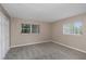Carpeted bedroom with natural light from two windows and a spacious closet for storage at 1881 Stancel Dr, Clearwater, FL 33764