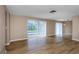 Bright living room with hardwood floors and sliding glass doors leading to the pool at 1881 Stancel Dr, Clearwater, FL 33764