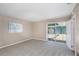Spacious living room with neutral carpet and sliding glass door offering backyard and pool views at 1881 Stancel Dr, Clearwater, FL 33764