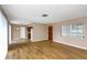 Sunny living room with beautiful hardwood floors and an entry door leading to other rooms at 1881 Stancel Dr, Clearwater, FL 33764