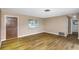 Bright living room with hardwood floors and an entry door leading to other rooms at 1881 Stancel Dr, Clearwater, FL 33764