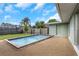 A lovely backyard featuring a refreshing swimming pool surrounded by a well-maintained lawn and a privacy fence at 1881 Stancel Dr, Clearwater, FL 33764
