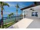A gorgeous balcony view includes wrought iron railings, water views, and tropical palm trees at 1901 Carolina Ne Ave, St Petersburg, FL 33703