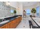 Bathroom with double vanity sink, marble walls, soaking tub, and stunning ocean view at 1901 Carolina Ne Ave, St Petersburg, FL 33703