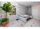 Bathroom with marble walls, shower, tub, and large green plant near the window at 1901 Carolina Ne Ave, St Petersburg, FL 33703