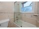 Bathroom featuring a shower over bath combination with beige tiles and an ocean view at 1901 Carolina Ne Ave, St Petersburg, FL 33703