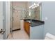 Well-appointed bathroom featuring a glass-enclosed shower, granite countertop vanity, and modern fixtures at 1901 Carolina Ne Ave, St Petersburg, FL 33703