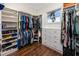 Spacious walk-in closet with custom shelving, hanging rods, and natural light at 1901 Carolina Ne Ave, St Petersburg, FL 33703
