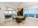 Bright dining room with water views features a stylish chandelier and seating for six at 1901 Carolina Ne Ave, St Petersburg, FL 33703