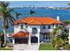 A stunning exterior view of a waterfront property, with a manicured lawn and a peek of the city skyline at 1901 Carolina Ne Ave, St Petersburg, FL 33703