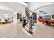 Foyer area showcasing a staircase with wrought iron railings and views of the dining and living spaces at 1901 Carolina Ne Ave, St Petersburg, FL 33703
