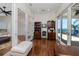 Bright home office featuring hardwood floors, built-in shelving and cabinets, and access to a balcony with water views at 1901 Carolina Ne Ave, St Petersburg, FL 33703
