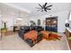 Open-concept living room with stylish furniture, a ceiling fan, and view to the dining room and staircase at 1901 Carolina Ne Ave, St Petersburg, FL 33703