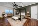 Luxurious main bedroom with a four-poster bed, water view, stylish decor and wood floors, creating a serene space at 1901 Carolina Ne Ave, St Petersburg, FL 33703