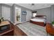 Comfortable main bedroom with wood floors, neutral colors, and ensuite bathroom access offering a relaxing retreat at 1901 Carolina Ne Ave, St Petersburg, FL 33703