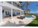 Covered patio area with comfortable seating, a large outdoor television, and a stunning view of the pool and ocean at 1901 Carolina Ne Ave, St Petersburg, FL 33703