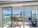 Balcony with table and chairs overlooks water views, perfect for relaxing and enjoying the scenery at 19925 Gulf Blvd # 402, Indian Shores, FL 33785