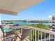 Balcony with waterfront view featuring a table and chairs, offering an ideal spot for outdoor dining at 19925 Gulf Blvd # 402, Indian Shores, FL 33785