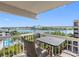 Balcony view showcases seating and panoramic water views, blending indoor comfort with outdoor beauty at 19925 Gulf Blvd # 402, Indian Shores, FL 33785