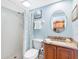 Clean bathroom featuring a shower with patterned curtain, a toilet, and a wooden vanity at 19925 Gulf Blvd # 402, Indian Shores, FL 33785