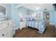 Bright bedroom featuring coastal decor, wood floors, and a comfortable queen-size bed at 19925 Gulf Blvd # 402, Indian Shores, FL 33785