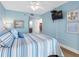 Inviting bedroom with coastal-themed decor, TV, and a view of the ensuite bathroom at 19925 Gulf Blvd # 402, Indian Shores, FL 33785
