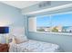 Well-lit bedroom with a twin bed and a window offering a view of the ocean at 19925 Gulf Blvd # 402, Indian Shores, FL 33785