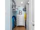 Functional closet space featuring a dresser, storage shelves, and beach equipment at 19925 Gulf Blvd # 402, Indian Shores, FL 33785