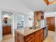 Modern kitchen featuring granite countertops and stainless steel appliances, seamlessly connecting to a bedroom at 19925 Gulf Blvd # 402, Indian Shores, FL 33785