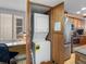 Efficient stacked washer and dryer setup in custom wood cabinet adjacent to desk area and stainless steel refrigerator at 19925 Gulf Blvd # 402, Indian Shores, FL 33785