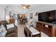 Bright living room featuring tile floors, comfortable seating, TV, and views toward the dining area and waterway at 19925 Gulf Blvd # 402, Indian Shores, FL 33785