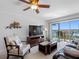 Cozy living room with a TV, furnishings, and sliding glass doors leading to a scenic balcony with water views at 19925 Gulf Blvd # 402, Indian Shores, FL 33785