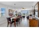 Open concept living and dining area with tile floors, water view, dining table and large sliding glass doors at 19925 Gulf Blvd # 402, Indian Shores, FL 33785
