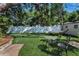 Lush backyard featuring a hammock, bistro set, artificial grass, and a shade tree at 202 S Hesperides St, Tampa, FL 33609