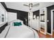 Bedroom boasting black walls, hardwood floors, and white furniture at 202 S Hesperides St, Tampa, FL 33609