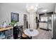 Dining area with a marble table, stylish chairs, chandelier, and view of the adjacent kitchen area at 202 S Hesperides St, Tampa, FL 33609