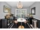 Bright dining area with a round marble table, stylish chairs, modern chandelier, and buffet with drinkware at 202 S Hesperides St, Tampa, FL 33609