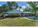 Charming brick home with a landscaped yard and walkway at 202 S Hesperides St, Tampa, FL 33609