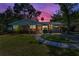 Charming brick home featuring manicured lawn, sidewalk, and meticulous landscaping creates a welcoming curb appeal at 202 S Hesperides St, Tampa, FL 33609