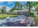 Home featuring a well-maintained driveway and landscaping at 202 S Hesperides St, Tampa, FL 33609