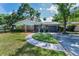 Charming brick home with a landscaped yard and walkway at 202 S Hesperides St, Tampa, FL 33609
