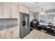 Bright kitchen showcasing stainless steel refrigerator and breakfast nook at 202 S Hesperides St, Tampa, FL 33609