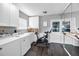 Bright laundry room with a washer, dryer, exercise bike, and wood-look floors at 202 S Hesperides St, Tampa, FL 33609