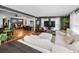 Open concept living and dining room area with a white couch and dark accent walls at 202 S Hesperides St, Tampa, FL 33609