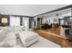Open concept living room featuring white couch and dark accent walls at 202 S Hesperides St, Tampa, FL 33609