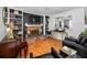 Elegant living room with a brick fireplace, built-in shelves, and hardwood floors for a cozy atmosphere at 202 S Hesperides St, Tampa, FL 33609