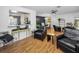 Inviting living room with wood floors, stylish decor, and an open layout to the dining and kitchen areas at 202 S Hesperides St, Tampa, FL 33609