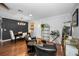 Cozy living room featuring hardwood floors, black accent wall and dining table with chairs at 202 S Hesperides St, Tampa, FL 33609